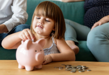 O que aprendemos com mamãe e papai sobre dinheiro crança colocando dinheiro no cofre